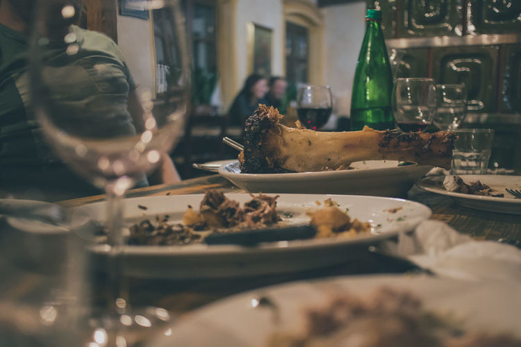 Midsection of man with leftovers on table in restaurant
