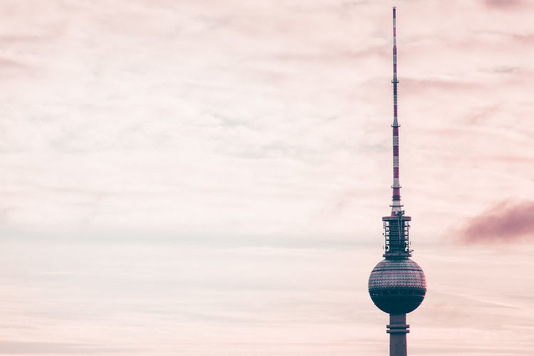 Low angle view of fernsehturm against sky during sunset