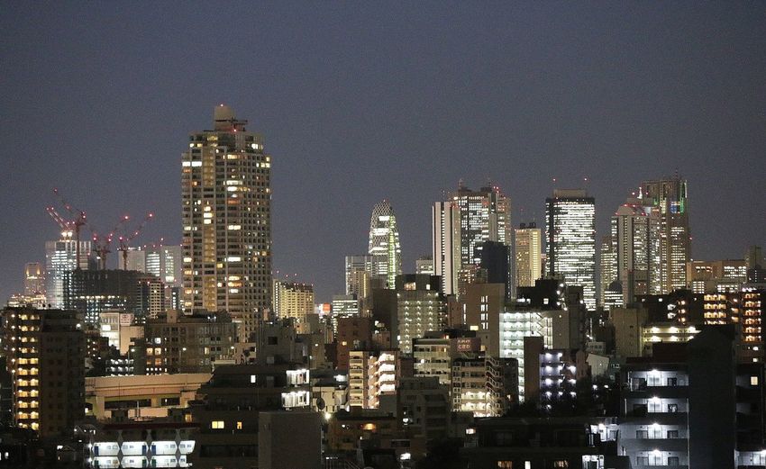 High angle view of illuminated cityscape against sky at night