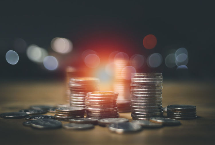 Business finance and money save concept rows of coins lined up there is a graph showing growth 