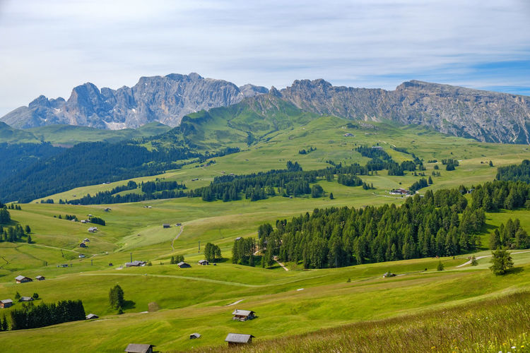 View of a valley in the alps with meadows and barns