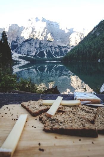 High angle view of ice cream by lake against mountains