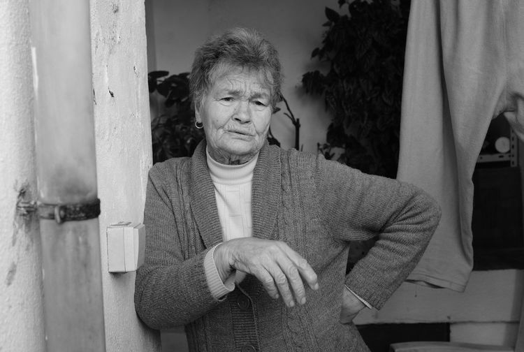 Portrait of grandma sitting with arms raised