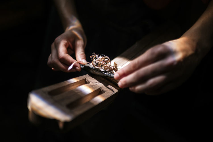 Unrecognized luthier woman in traditional workshop