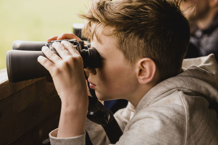 Portrait of boy holding camera