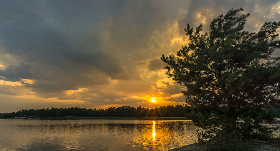 Scenic view of lake against sky during sunset