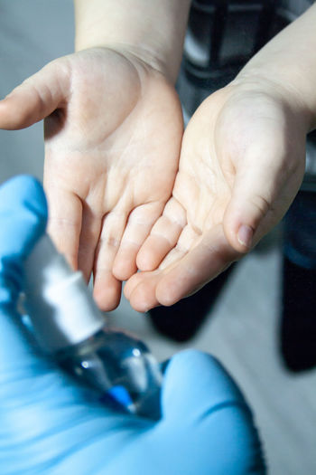 Doctor treats children's hands with an antiseptic
