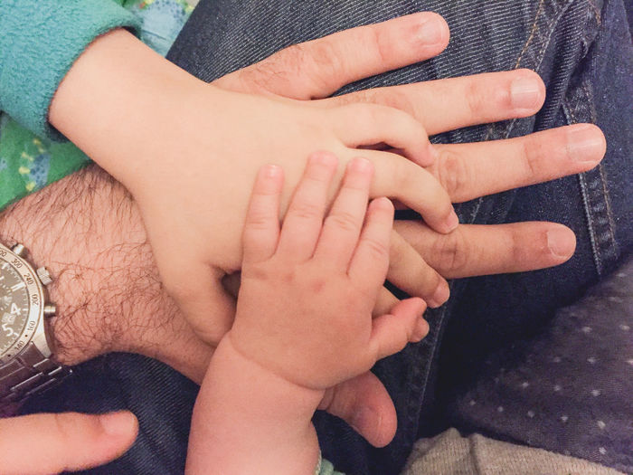 Cropped image of family with stacked hands