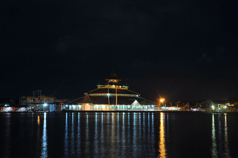 Illuminated historic mosque at waterfront