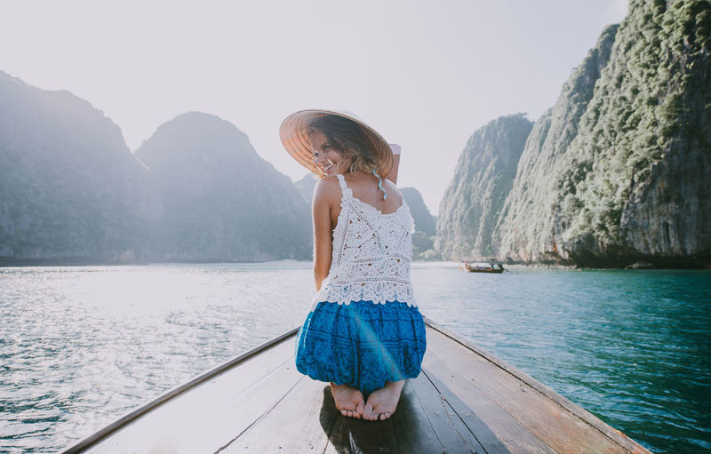 Woman on longtail boat in sea