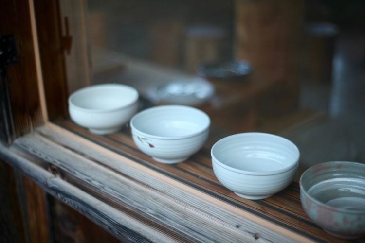 High angle view of bowls on cabinet