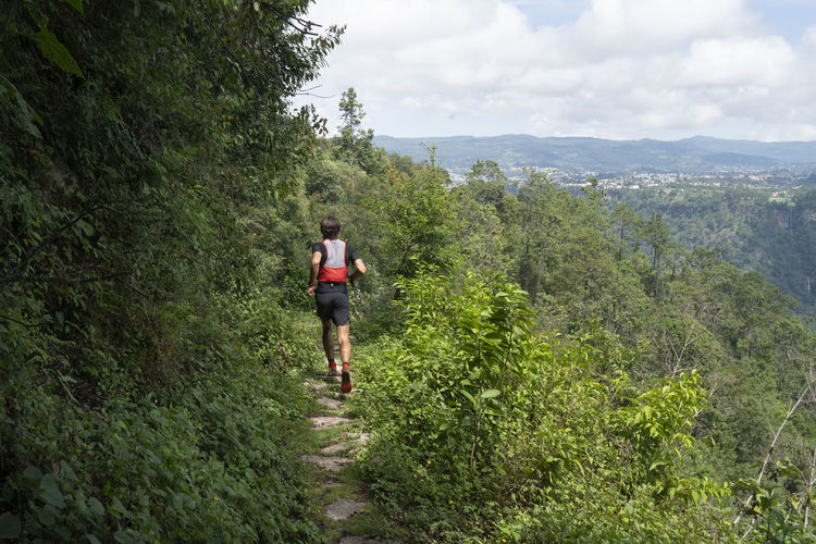 One man running on a trail in the mountains of zacatlan, puebla