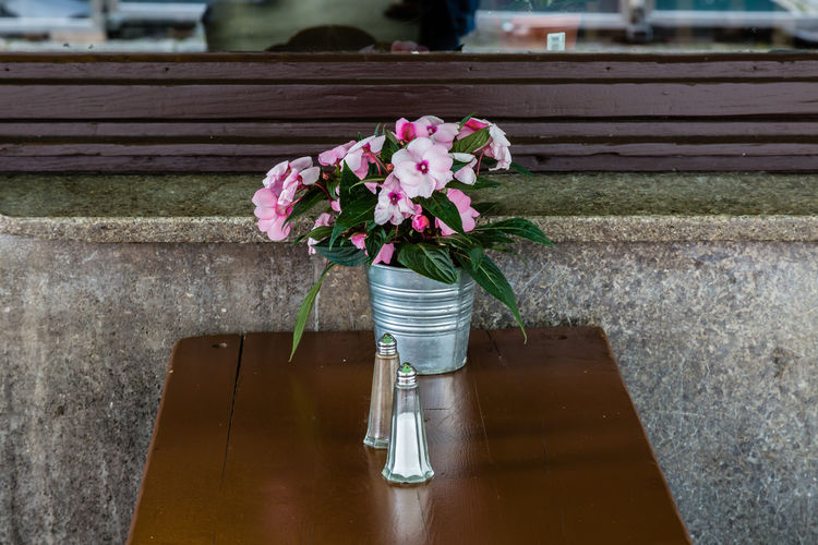 Flowers in container on table in restaurant