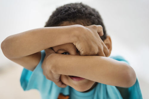 Close-up portrait of cute boy against white background