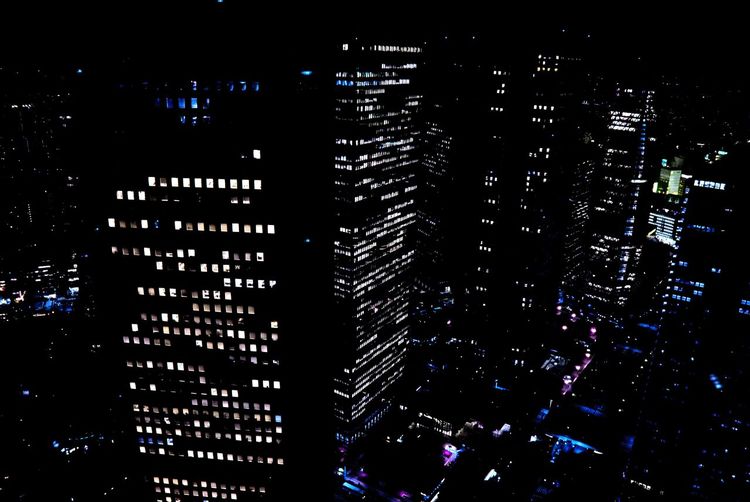 Illuminated modern buildings in city at night