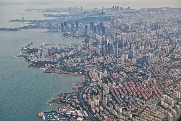 Aerial view of cityscape by sea