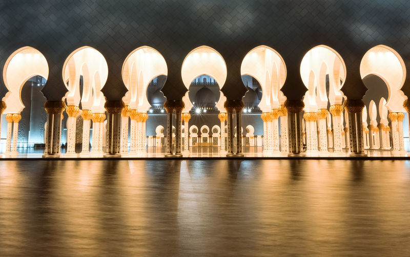 Lake against illuminated sheikh zayed mosque
