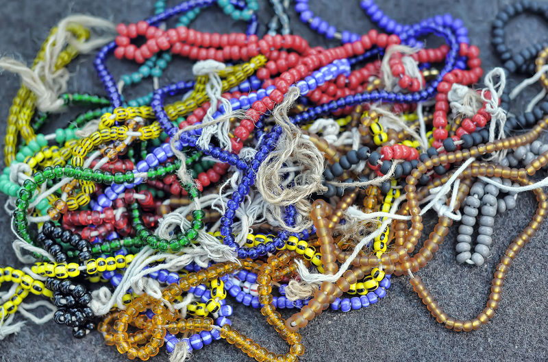 High angle view of multi colored bead necklace on ground