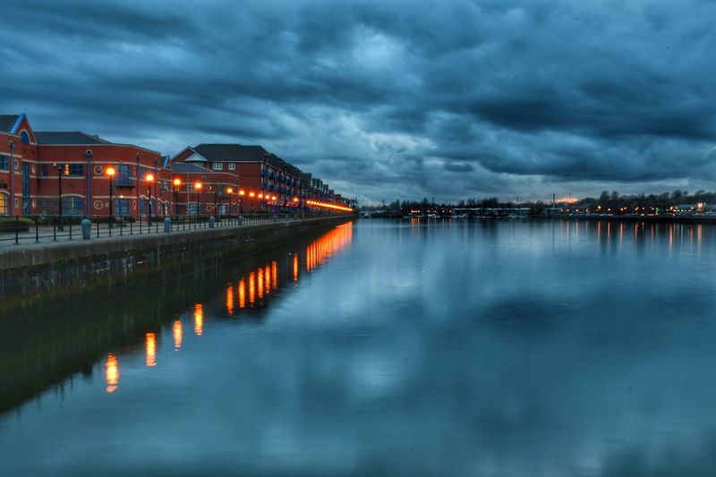 Reflection of illuminated sky in water at night
