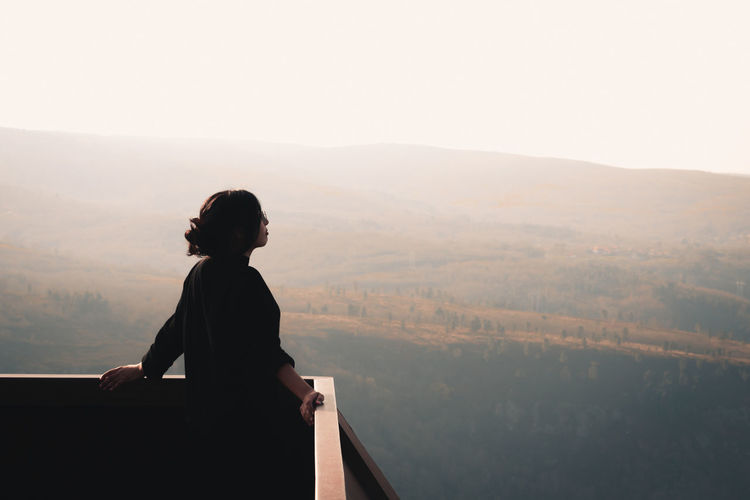 Rear view of man standing on mountain