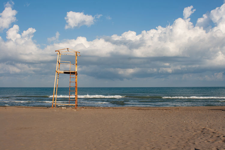 Lifeguard hut on beach against sky