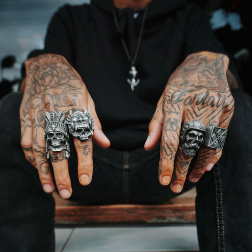 Midsection of man wearing skull ring