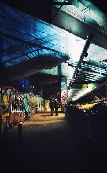 Man walking in illuminated city