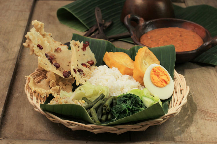 Nasi pecel. traditional javanese rice dish of steamed rice with vegetable salad, 