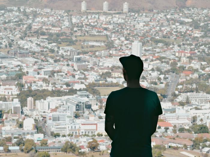Rear view of man looking at cityscape