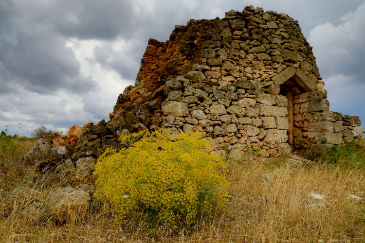 Old ruin building against cloudy sky