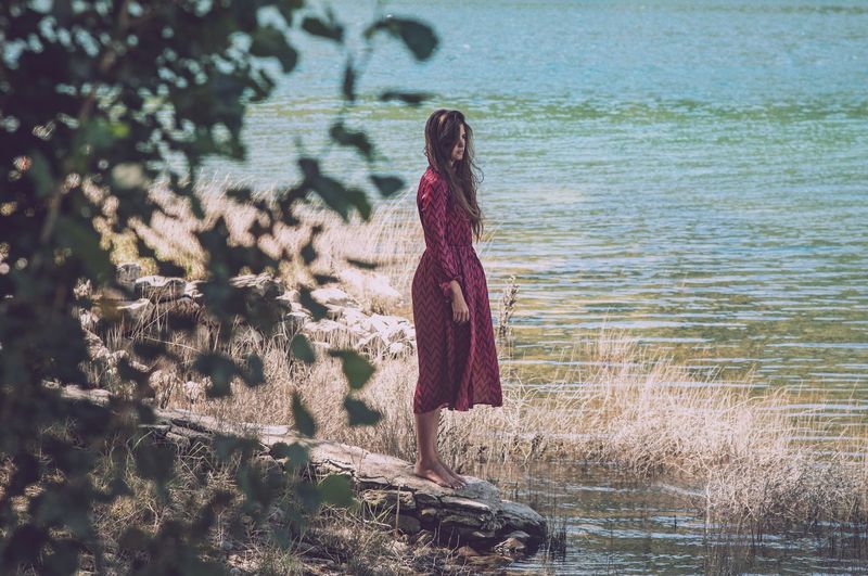 Woman standing by lake