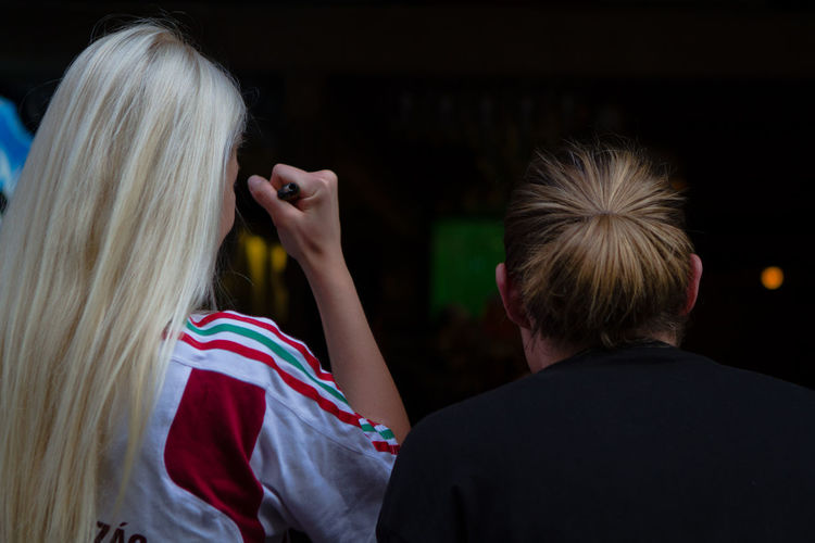 Close-up of woman from the back  cheering blonde hair 