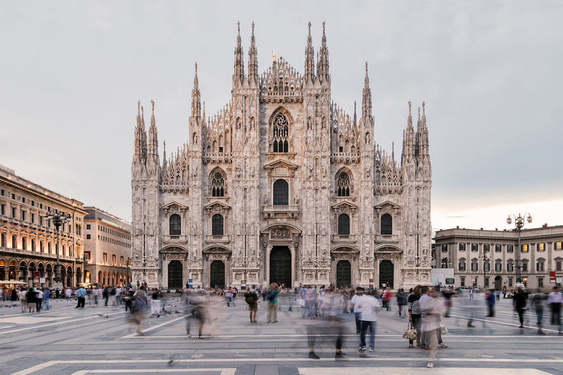 People at milan cathedral against sky