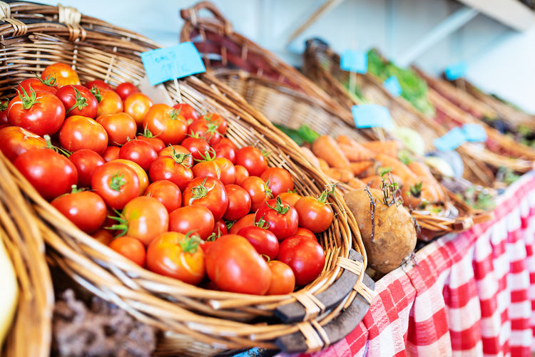 Tomatoes in basket for sale at market stall