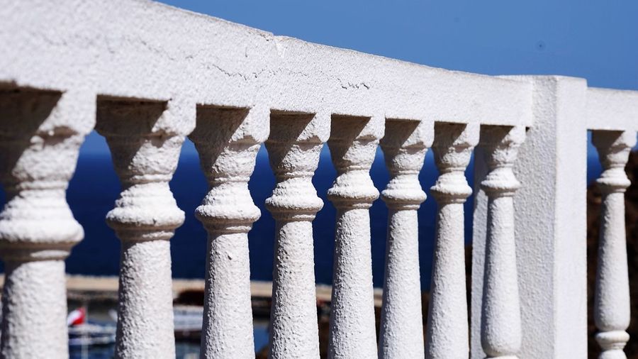 Close-up of railing against blue sky