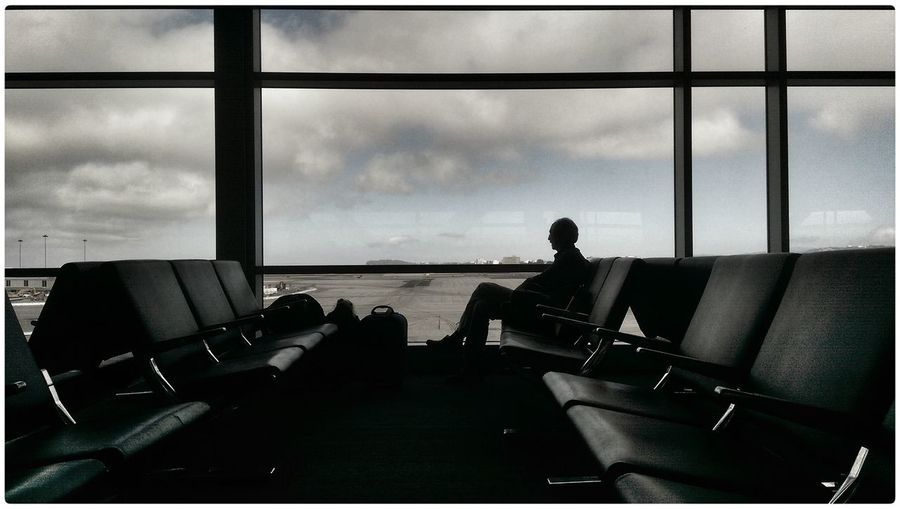 Silhouette of person in airport waiting for flight
