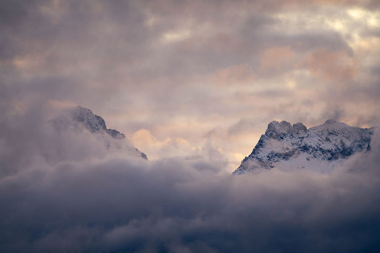 Low angle view of snow covered mountain against sky