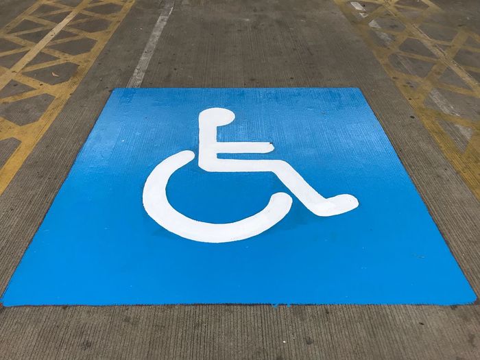 High angle view of disabled access sign at parking lot