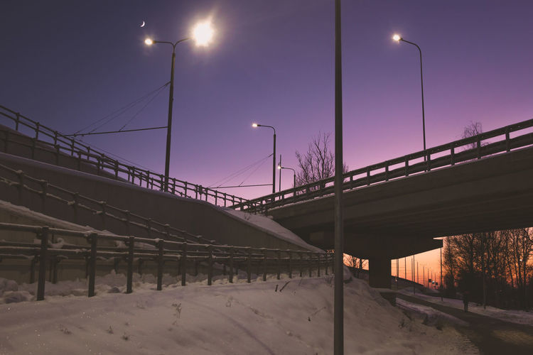 Bridge over street against sky during winter
