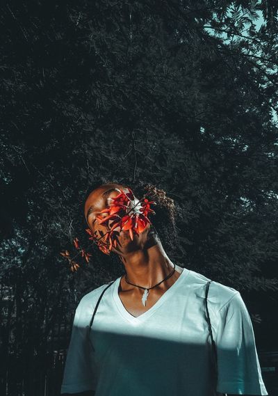 Portrait of woman standing against plants