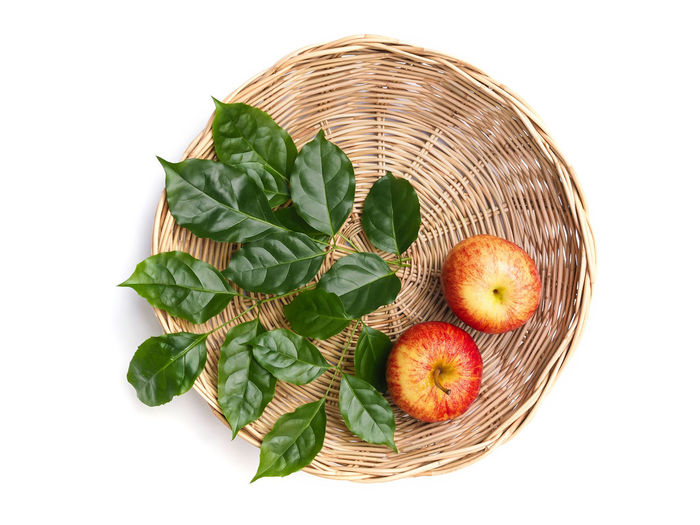 Fruits in basket on white background