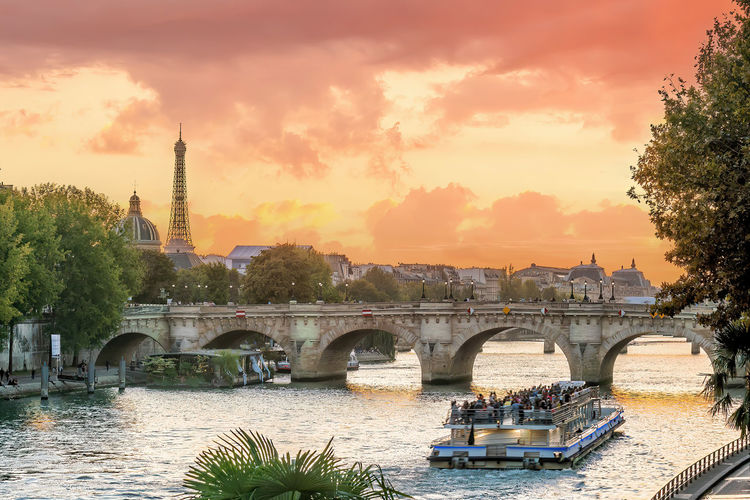 Bridge over river against sky during sunset