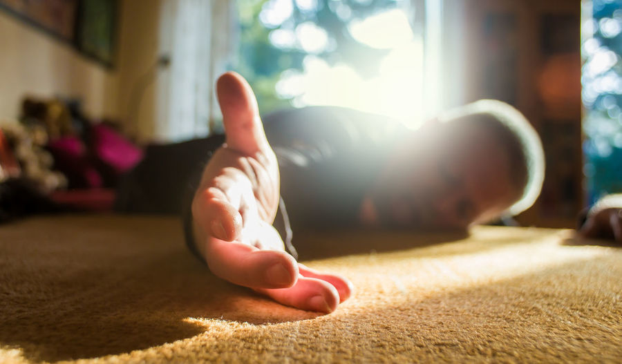 Man lying on floor at home