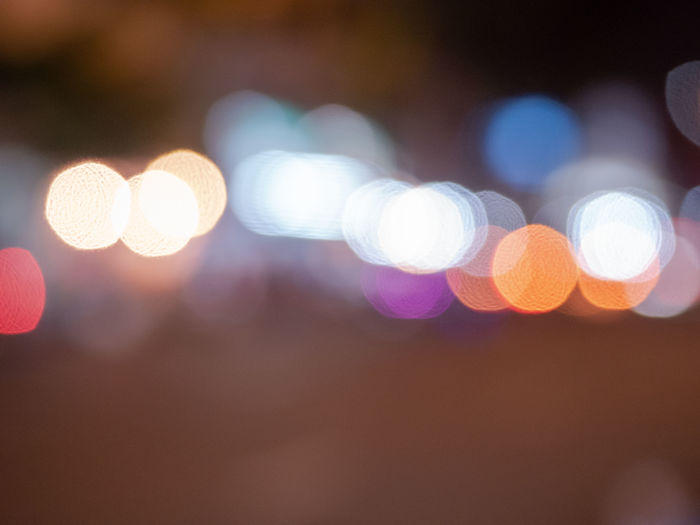 Defocused image of illuminated lights on street