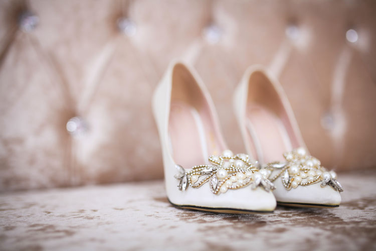Close-up of ornate shoes on floor