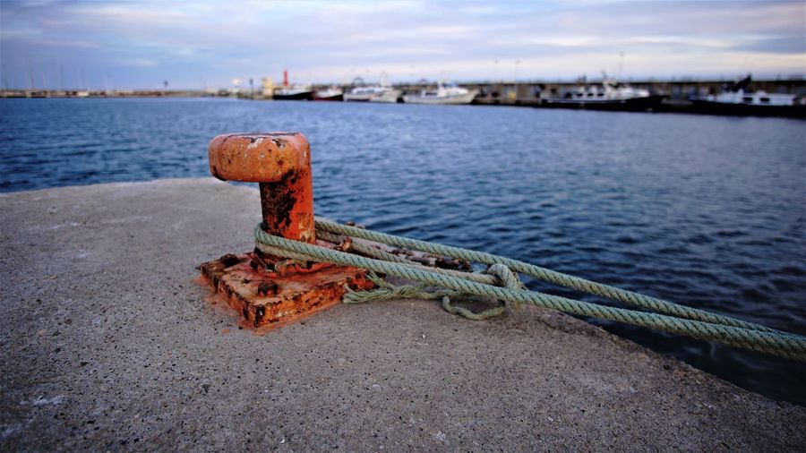 Close-up of rope tied on pier