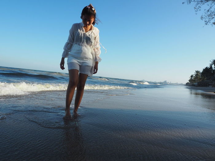 Full length of young woman on beach