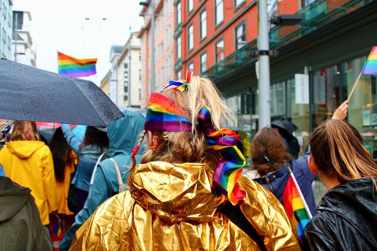 Rear view of people walking in gay pride parade