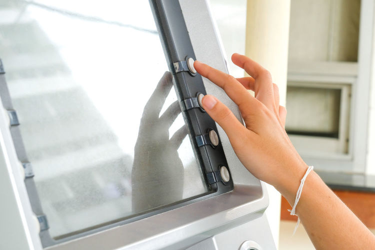Cropped hand using atm machine