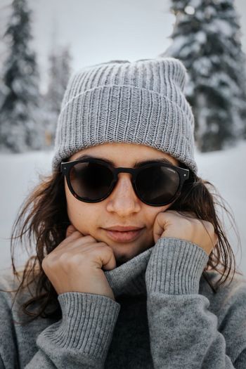 Portrait of woman wearing sunglasses in winter